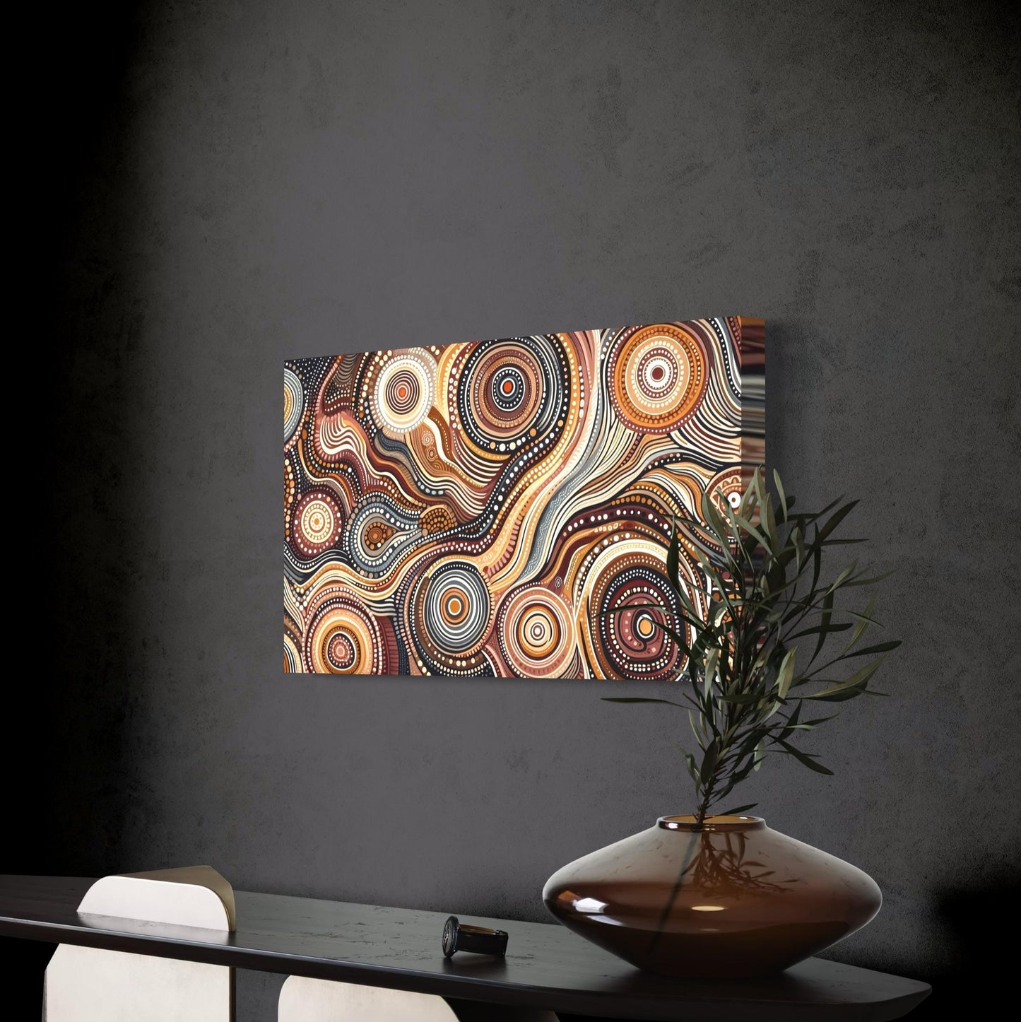 Walu Wirin Aboriginal dot painting horizontal print unframed, displayed on a dark textured wall above a modern black console table with a ceramic vase holding olive branches.
