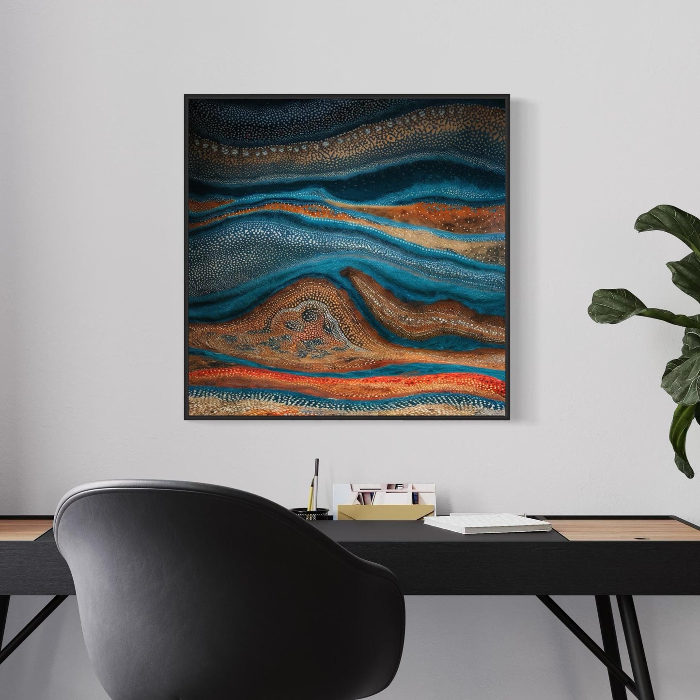 Karli Flow Aboriginal dot painting in a sleek black frame, styled above a minimalist black desk and chair setup, with soft natural lighting and a leafy plant on the side.