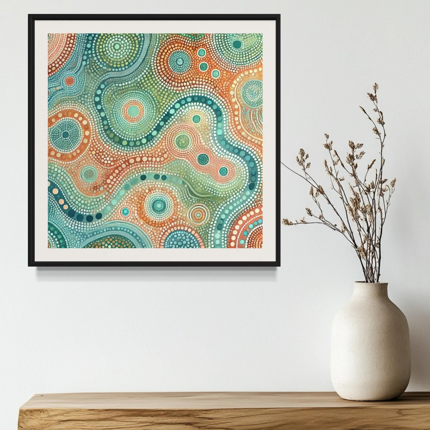 Ngapa Kuruwali Aboriginal dot painting printable framed on white wall above natural wood shelf with ceramic vase and dried foliage