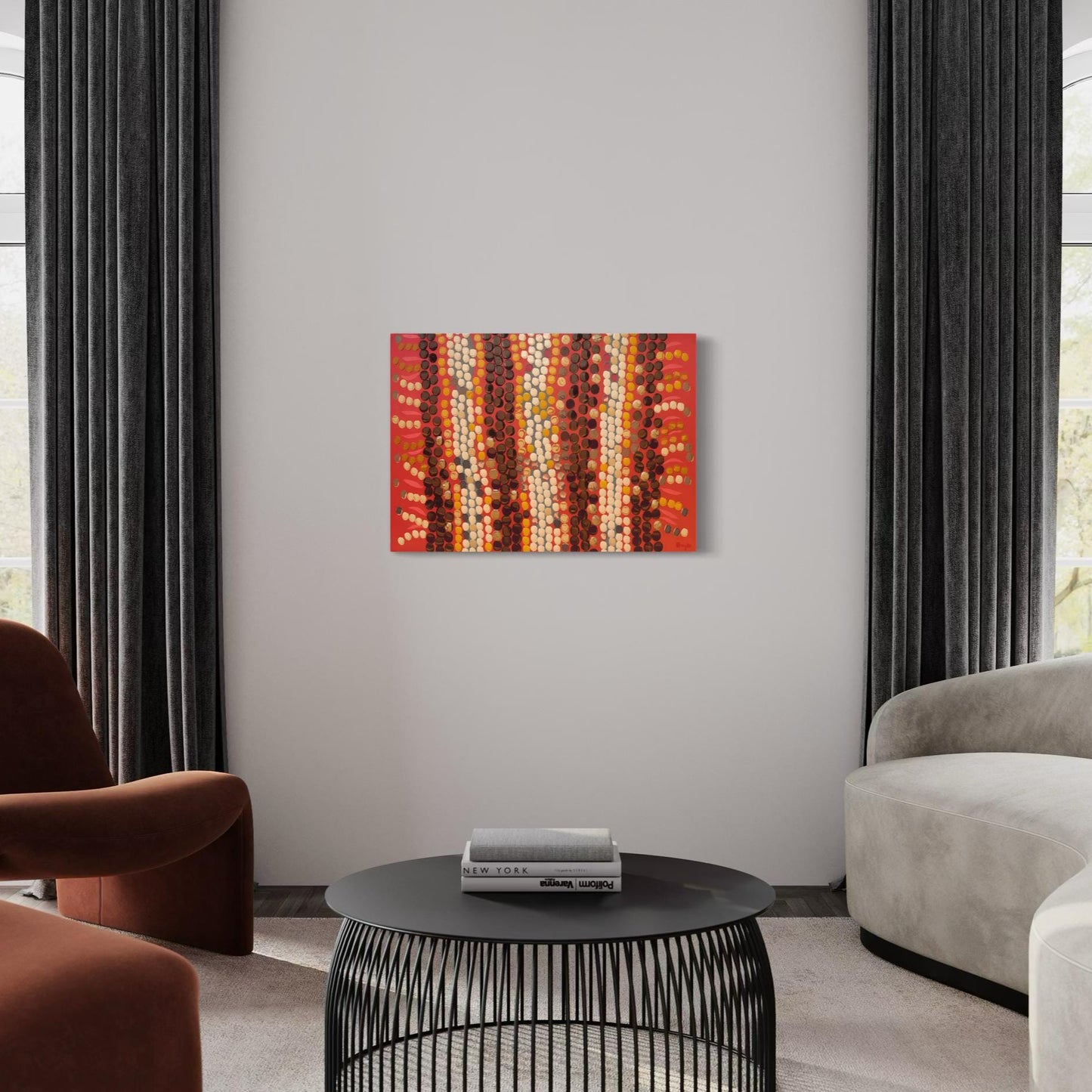 Horizontal Aboriginal dot painting in fiery reds, oranges, and browns, displayed in a modern living room with neutral tones, dark curtains, and curved seating around a black wire coffee table.