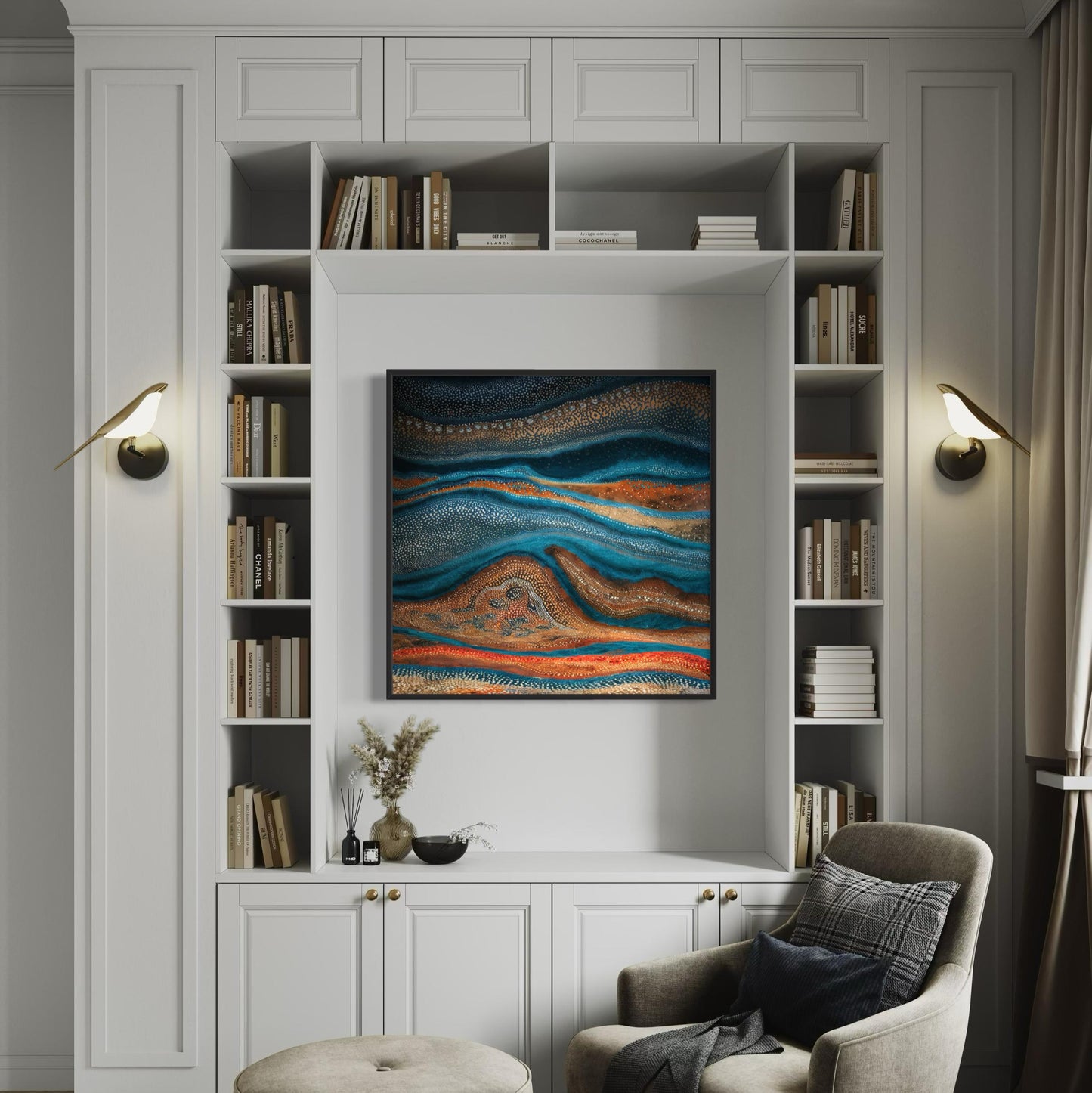 Karli Flow Aboriginal dot painting printable framed in black, displayed in built-in white bookcase nook with shelving, styled with neutral books and modern decor in a cozy reading corner.