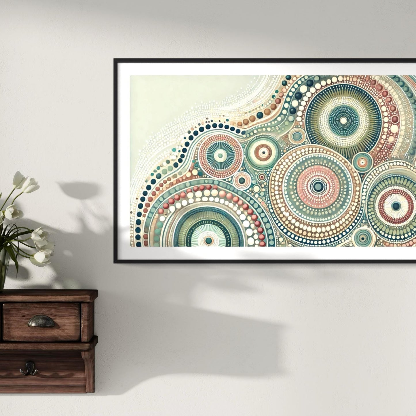 Yirrarn Aboriginal dot painting printable in pastel earth tones, framed above rustic wooden drawers with white tulip flowers in vase