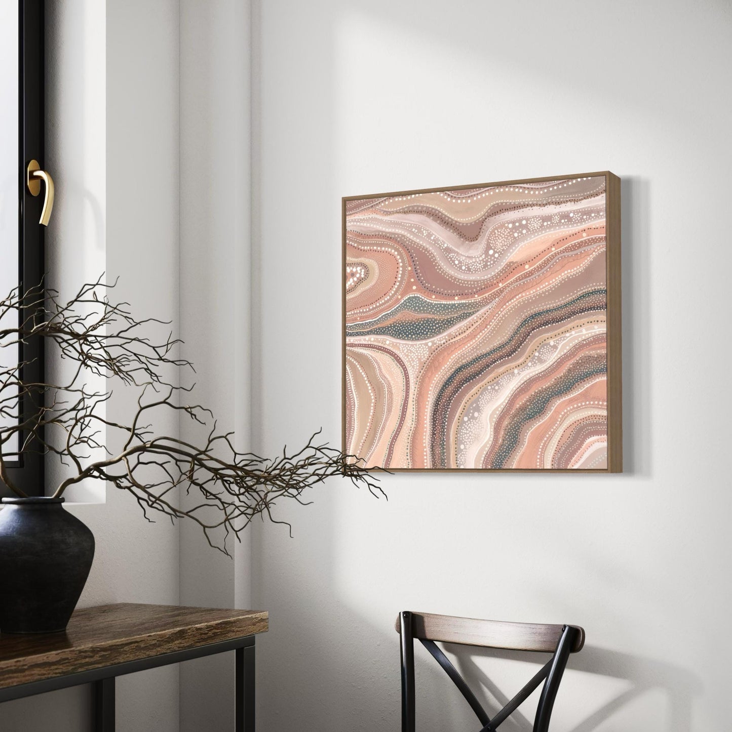 Marrinpa Aboriginal dot painting printable in earthy neutrals framed on white wall beside wooden table with black vase and branch decor