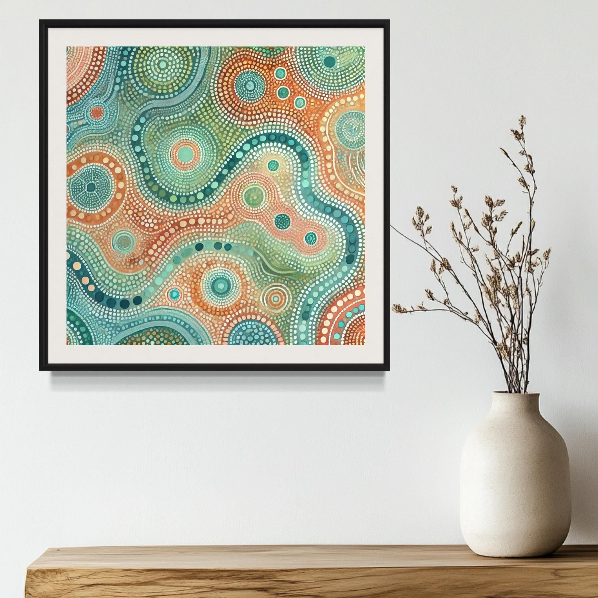 Ngapa Kuruwali Aboriginal dot painting printable framed on white wall above natural wood shelf with ceramic vase and dried foliage