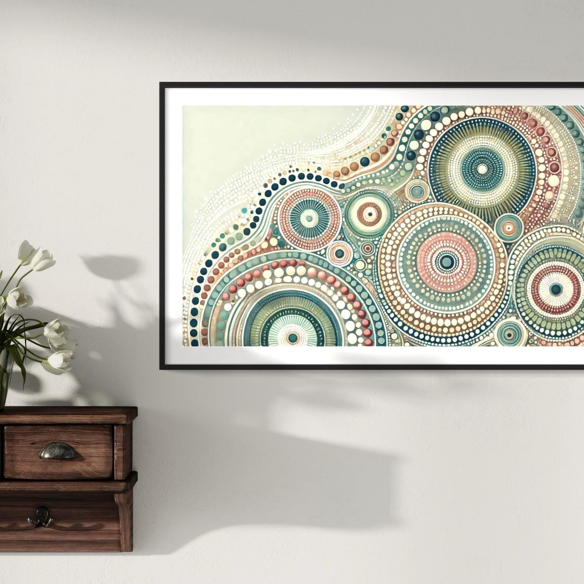 Yirrarn Aboriginal dot painting printable in pastel earth tones, framed above rustic wooden drawers with white tulip flowers in vase
